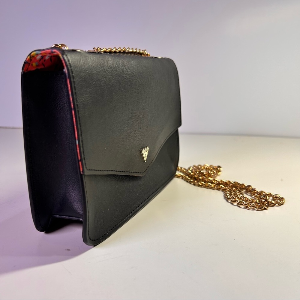 Guess Flap over handbag crossbody shoulder bag, black with gold chain strap.